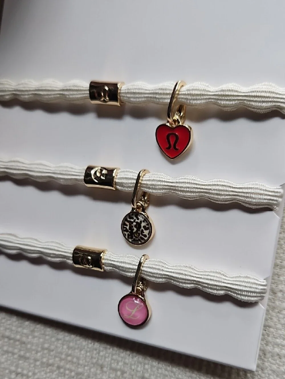 lululemon athletica Charm Hair Ties Trio — White Bands with Red & Pink Charms